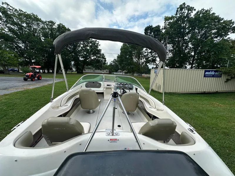 Slide: The Image of 2005 Sea Ray 185 Fish N Ski boat with canopy on grassy area. - 2