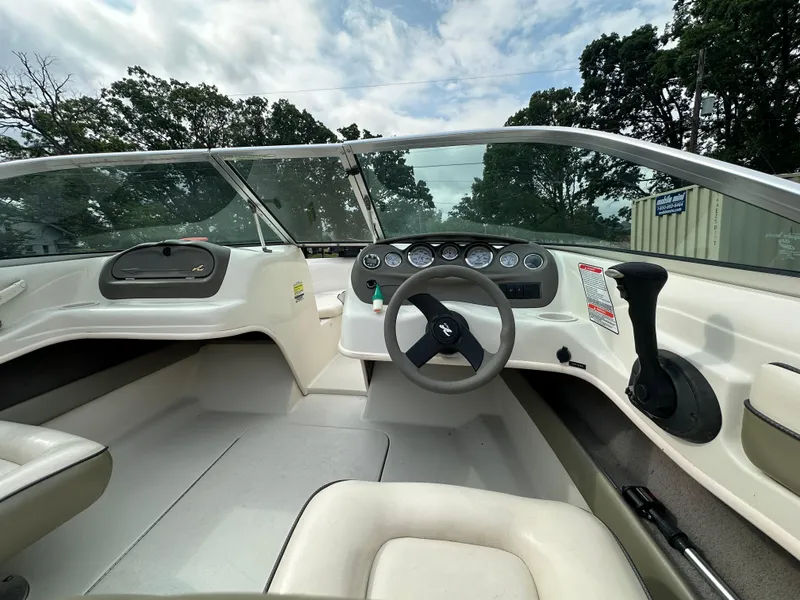 Slide: The Image of 2005 Sea Ray 185 Fish N Ski boat interior with steering wheel and dashboard controls. - 5