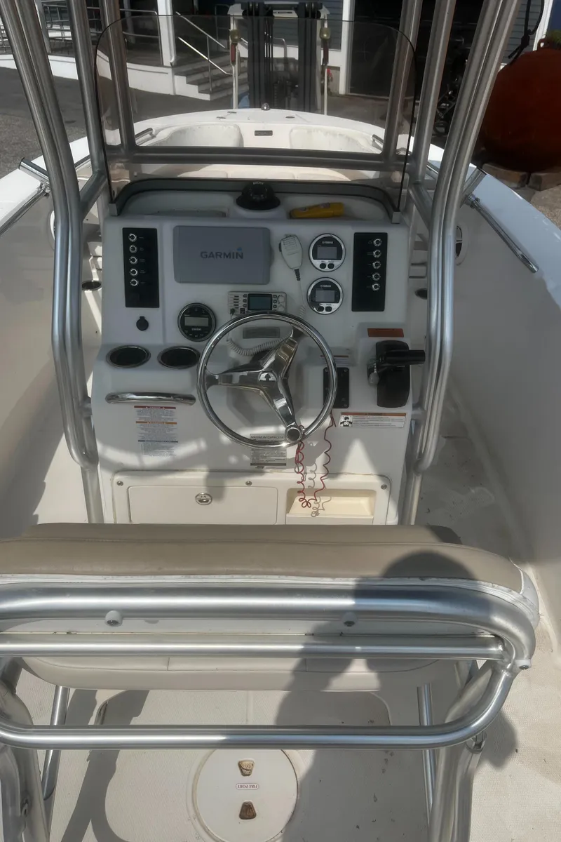 Slide: The Image of 2018 Robalo R200 Center Console boat interior with steering wheel and control panel. - 10