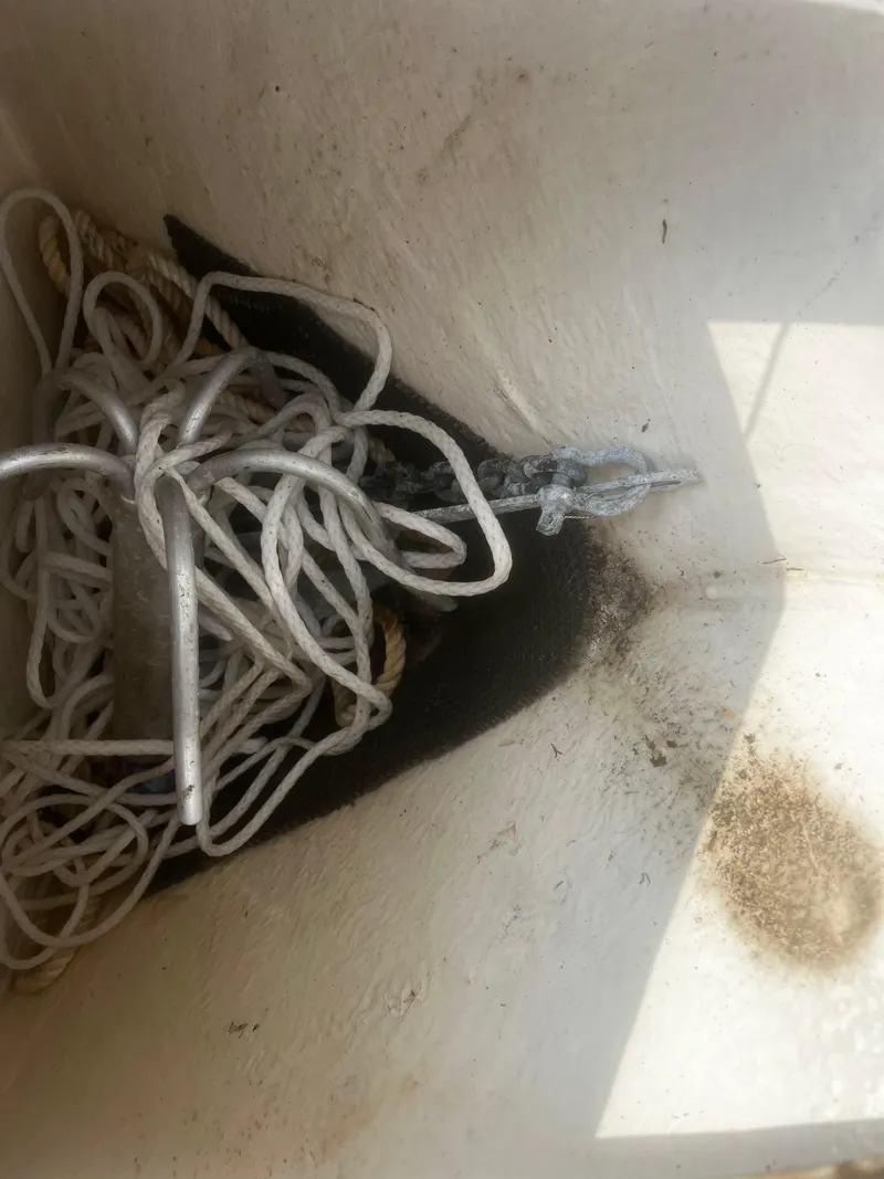 Slide: The Image of Robalo R200 Center Console 2018 anchor compartment with tangled rope. - 12