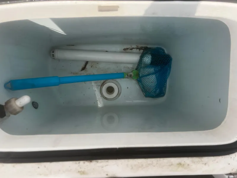 Slide: The Image of 2018 Robalo R200 Center Console livewell with blue net and plumbing. - 16