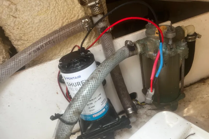 Slide: The Image of 2018 Robalo R200 Center Console boat pump system with hoses and wiring. - 19