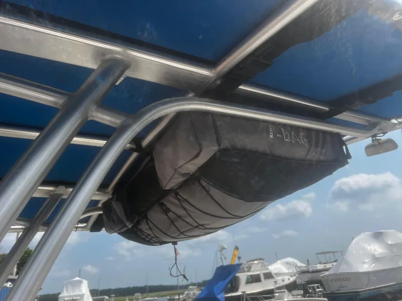 Slide: The Image of 2018 Robalo R200 Center Console boat with T-top and storage bag. - 23