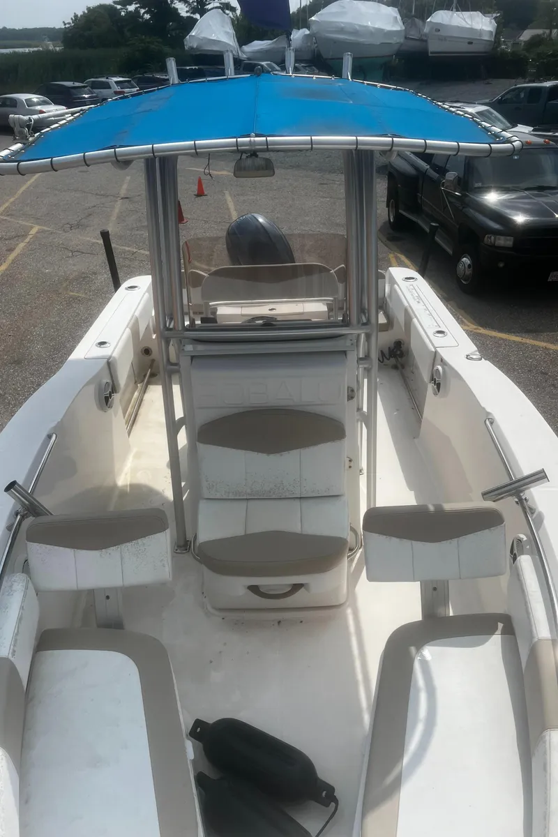 Slide: The Image of 2018 Robalo R200 Center Console boat with blue canopy in parking lot. - 8