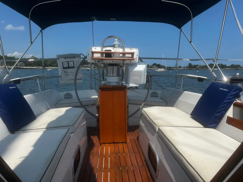 Slide: The Image of Cockpit of a 1990 Catalina 42 sailboat with cushioned seating and wooden flooring. - 12