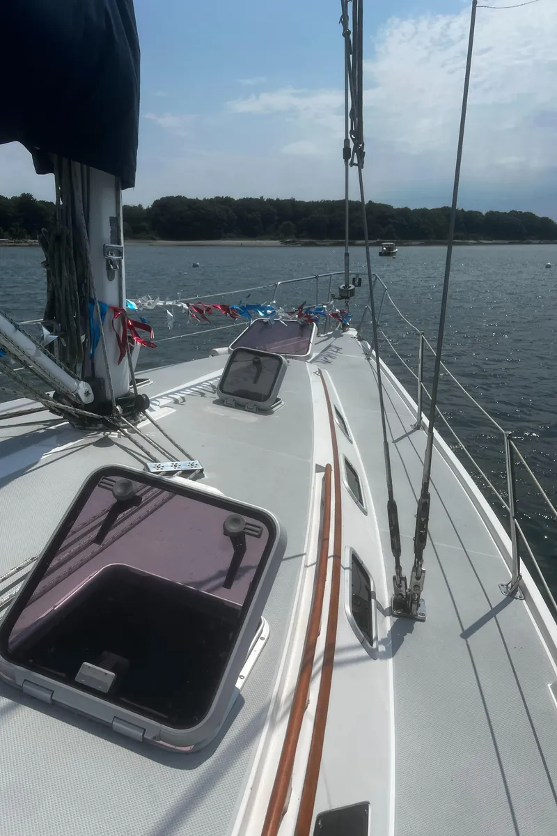 Slide: The Image of 1990 Catalina 42 sailboat on water, open hatches, scenic view. - 14