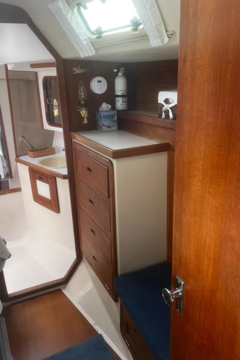 Slide: The Image of Interior of 1990 Catalina 42 sailboat with wooden cabinetry and seating. - 28