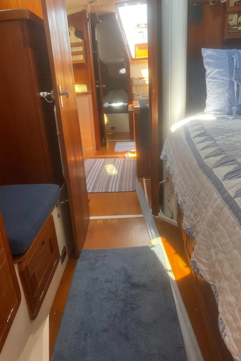 Slide: The Image of Interior of a 1990 Catalina 42 sailboat with cozy cabin and wooden furnishings. - 32
