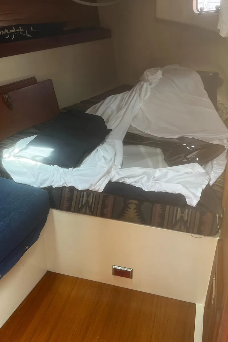 Slide: The Image of Interior cabin of a 1990 Catalina 42 sailboat with bed and wooden flooring. - 33