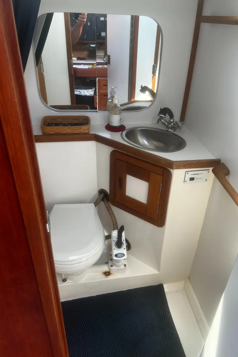 Slide: The Image of 1990 Catalina 42 yacht bathroom with sink, mirror, and toilet. - 36