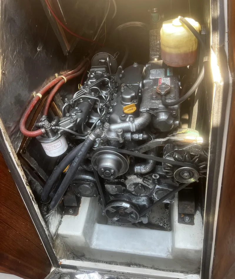 Slide: The Image of Engine compartment of a 1990 Catalina 42 sailboat, showcasing detailed mechanical components. - 37