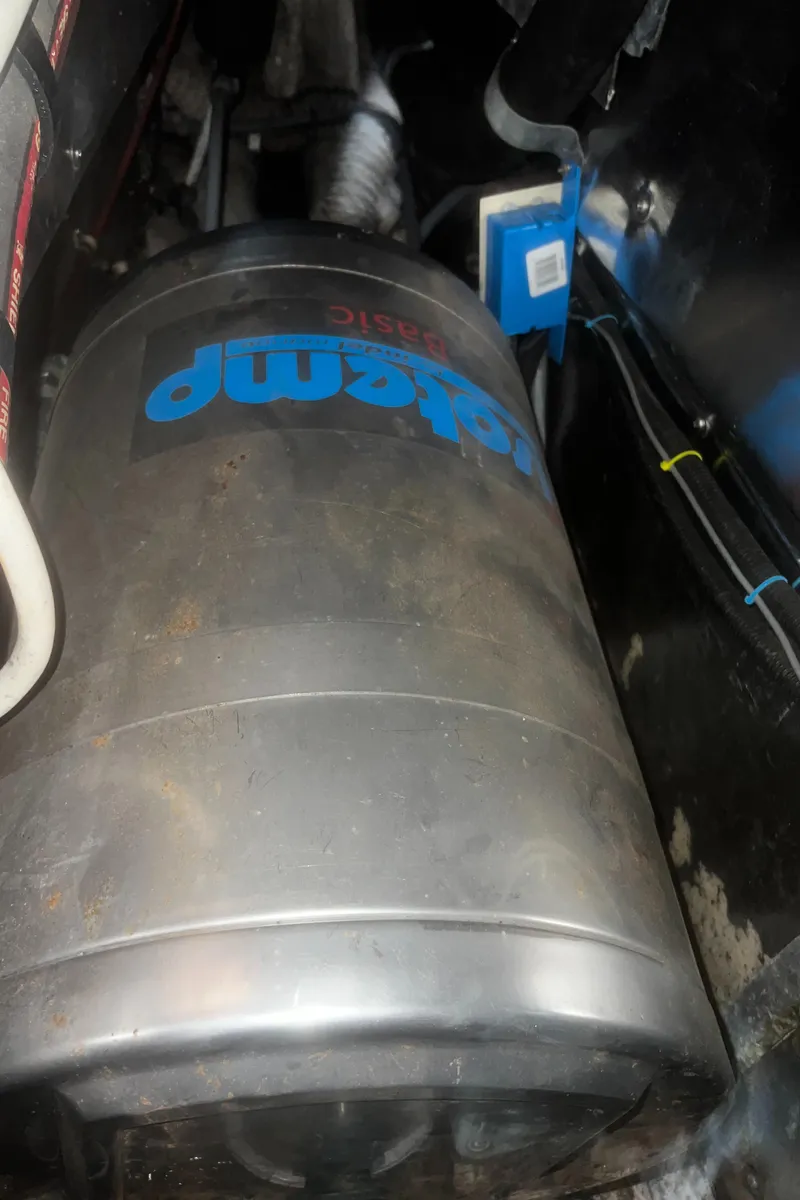 Slide: The Image of Catalina 42 1990 engine compartment with a large metallic tank. - 40