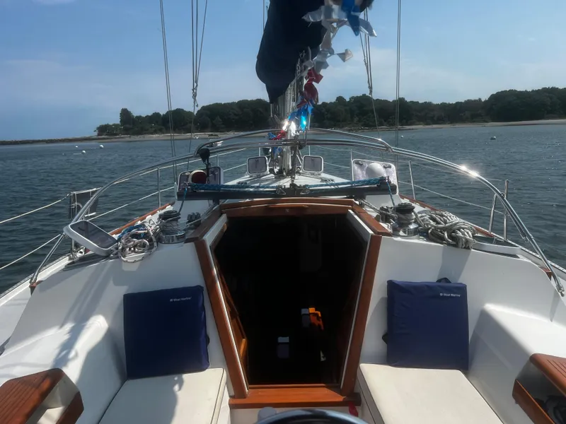 Slide: The Image of Sailboat cockpit view, Catalina 42, 1990 model, anchored near a scenic shoreline. - 5