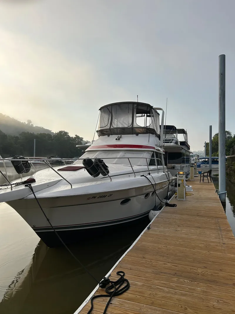 Slide: The Image of 1999 Silverton 37 Convertible yacht docked at marina. - 10