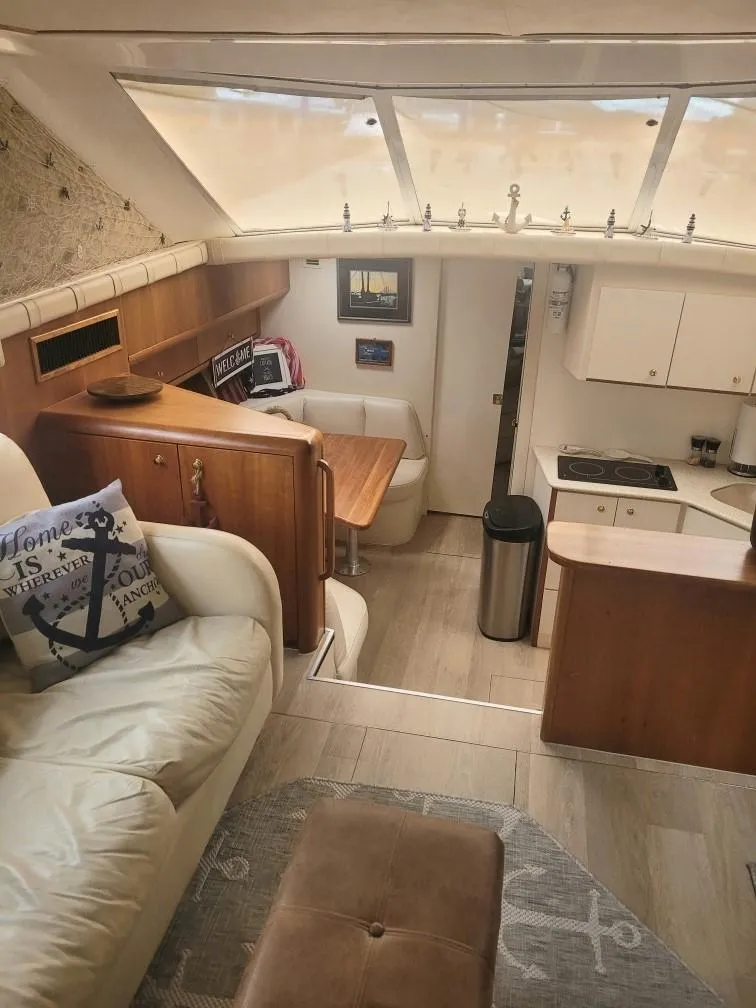 Slide: The Image of Interior of 1999 Silverton 37 Convertible yacht with cozy seating and kitchen area. - 28