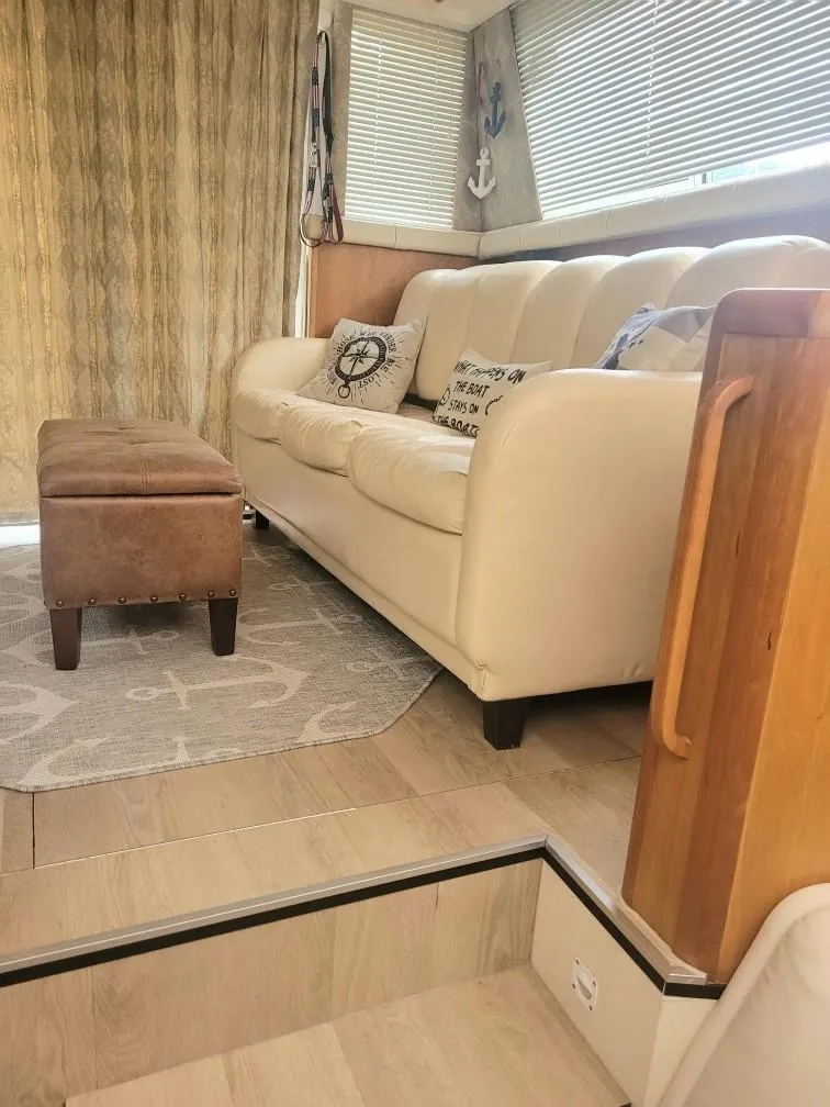 Slide: The Image of Interior of 1999 Silverton 37 Convertible yacht with beige sofa and nautical decor. - 29