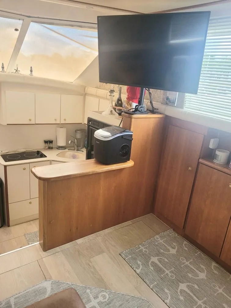 Slide: The Image of Interior of 1999 Silverton 37 Convertible yacht with kitchen and TV. - 32
