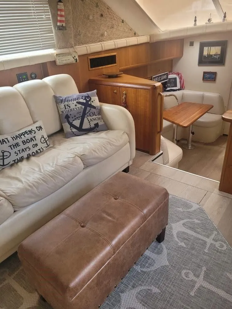 Slide: The Image of Interior of 1999 Silverton 37 Convertible yacht with cozy seating and nautical decor. - 33