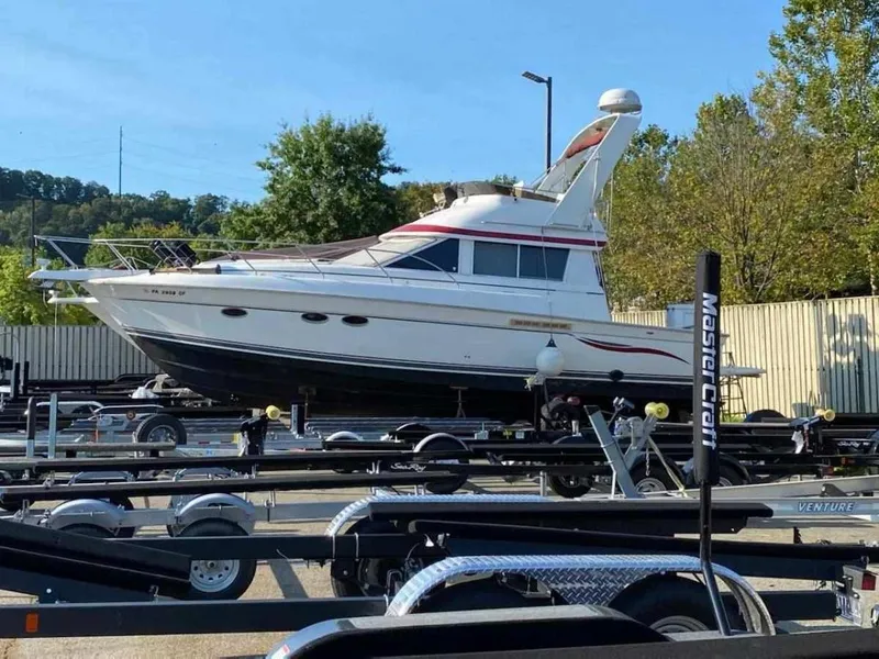 Slide: The Image of 1999 Silverton 37 Convertible yacht on trailer in outdoor storage area. - 4