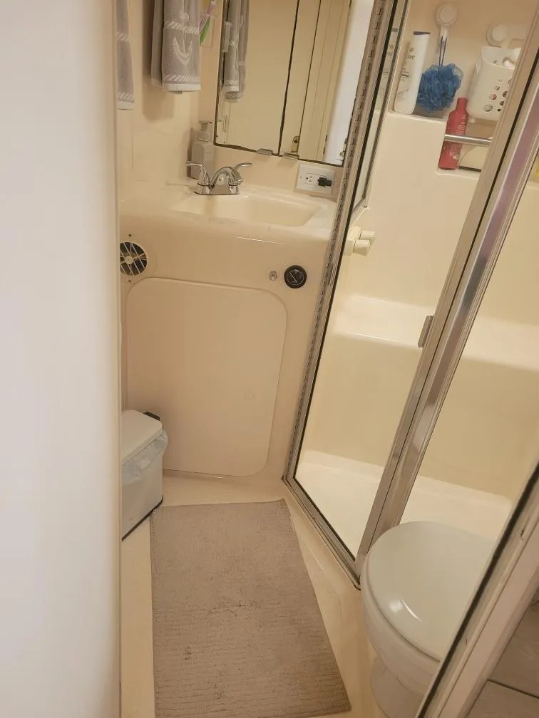 Slide: The Image of 1999 Silverton 37 Convertible bathroom with shower, sink, and toilet. - 40