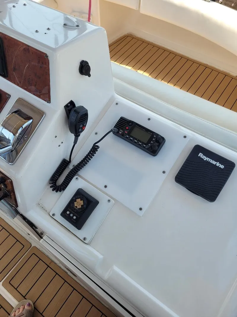Slide: The Image of 1999 Silverton 37 Convertible boat dashboard with radio and navigation equipment. - 43