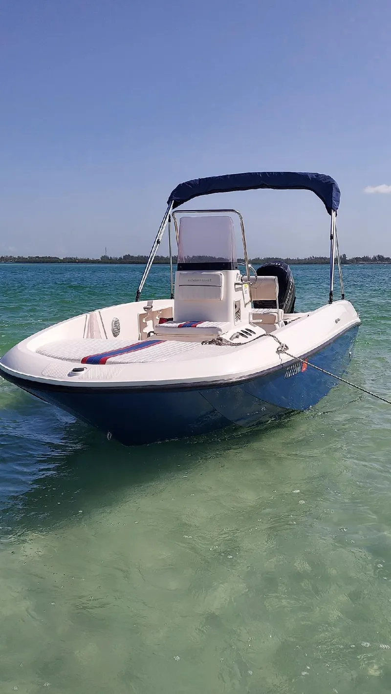 Slide: The Image of 2017 Bayliner Element F18 boat on clear turquoise water. - 1