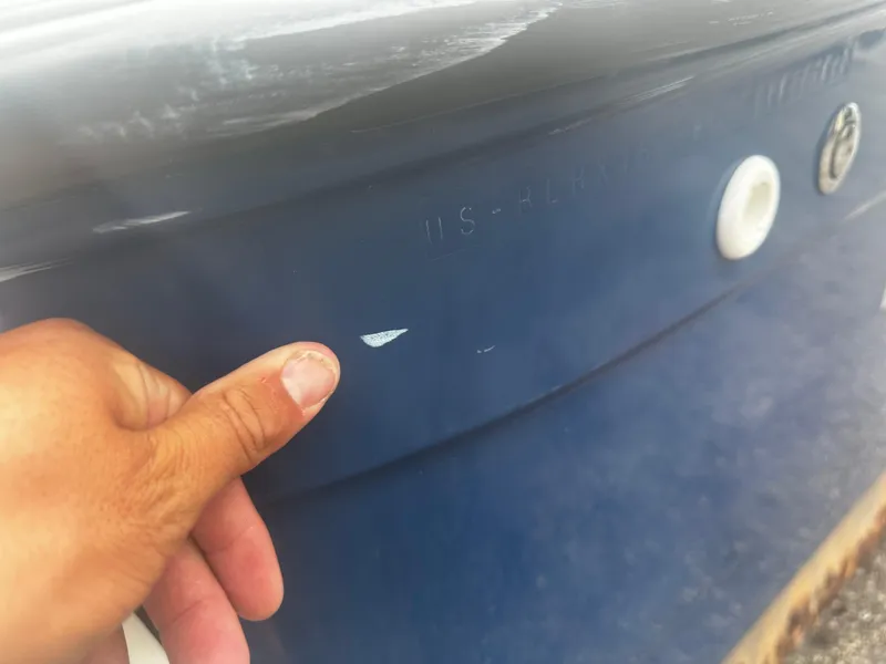 Slide: The Image of Close-up of a 2017 Bayliner Element F18 boat hull with minor damage. - 11
