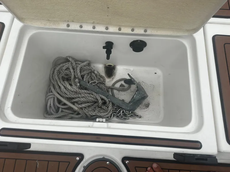 Slide: The Image of Anchor and rope storage in 2017 Bayliner Element F18 boat compartment. - 19