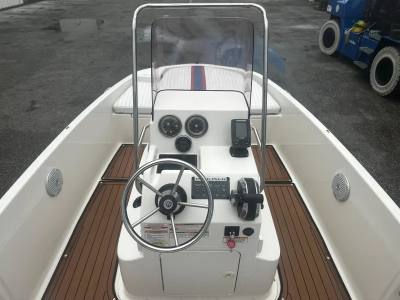 Slide: The Image of 2017 Bayliner Element F18 boat interior with steering console and gauges. - 23