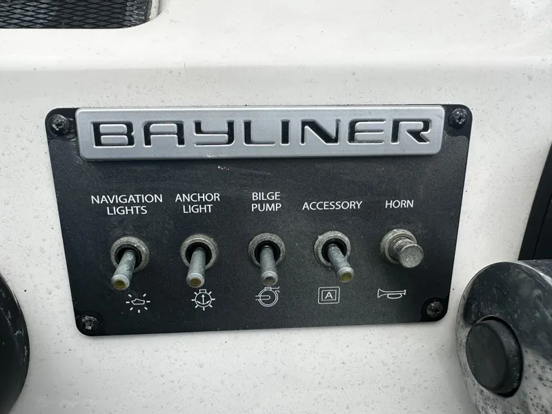 Slide: The Image of Control panel of 2017 Bayliner Element F18 boat with labeled switches. - 25