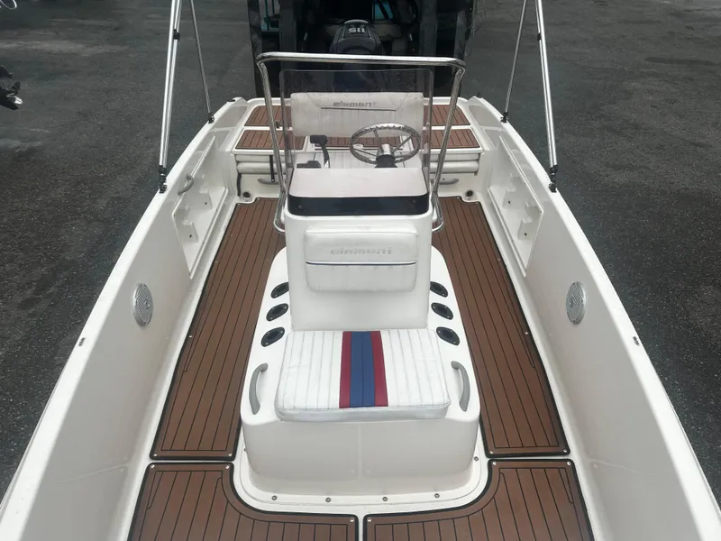 Slide: The Image of 2017 Bayliner Element F18 boat interior with wood-style flooring and central console. - 30