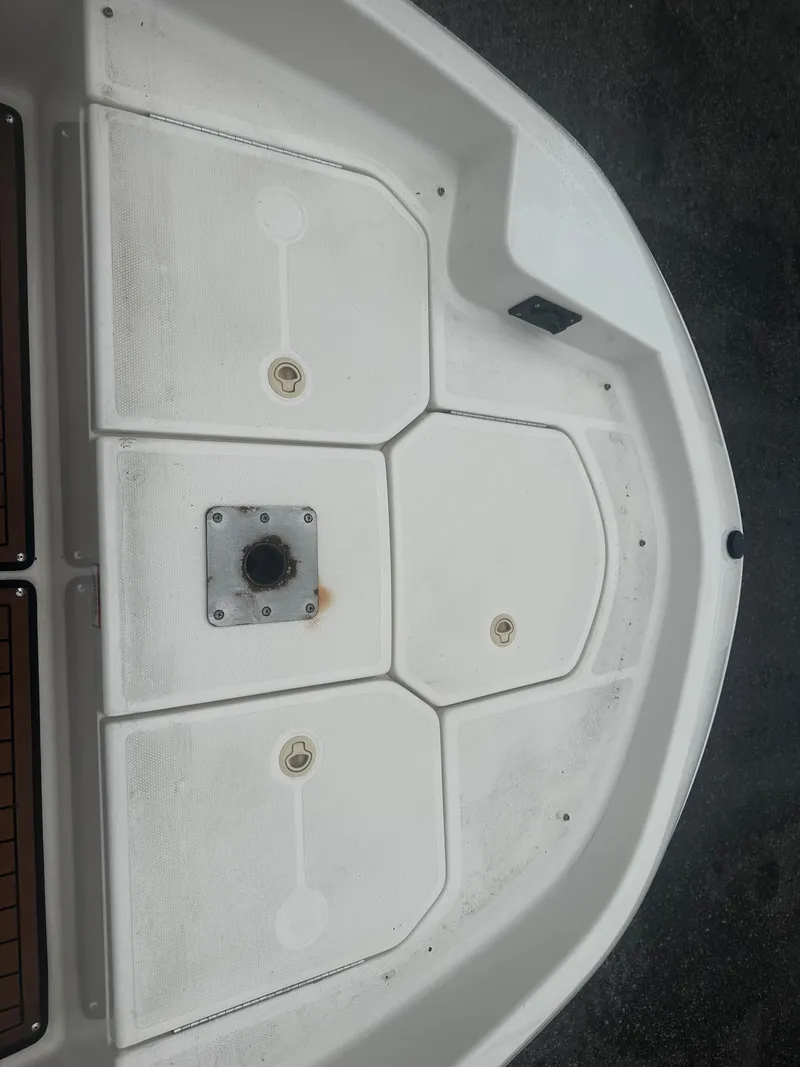 Slide: The Image of 2017 Bayliner Element F18 boat deck, white with storage compartments. - 33