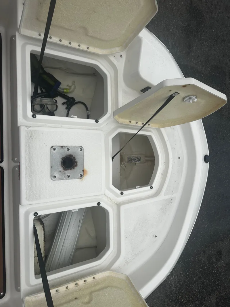 Slide: The Image of Open storage compartments on 2017 Bayliner Element F18 boat. - 34
