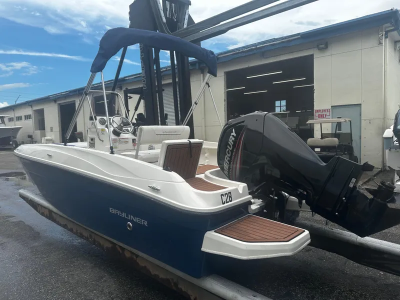 Slide: The Image of 2017 Bayliner Element F18 boat with Mercury engine, docked outdoors. - 6