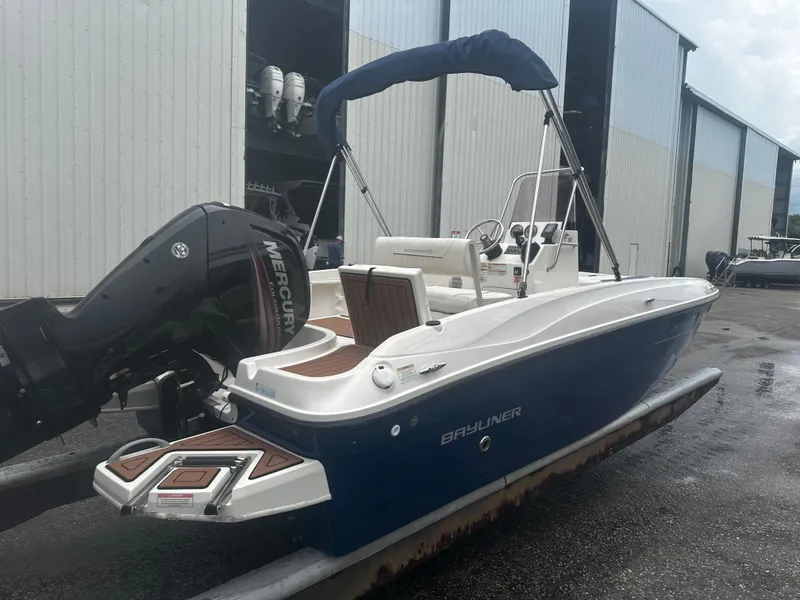 Slide: The Image of 2017 Bayliner Element F18 boat with Mercury engine, docked near storage facility. - 7