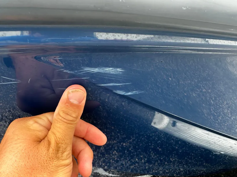 Slide: The Image of Close-up of scratches on a 2017 Bayliner Element F18 boat hull. - 9