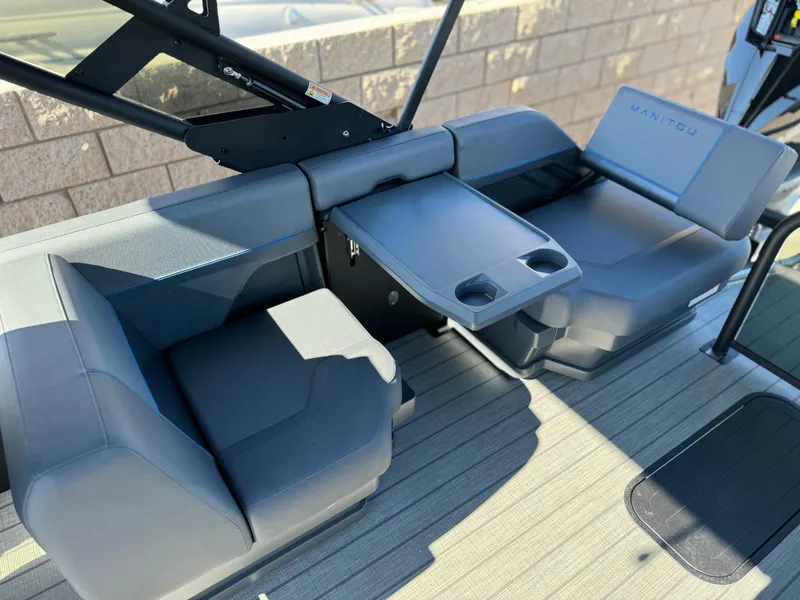 Slide: The Image of 2025 Manitou Explore 24 Switchback boat interior with trifold bench and dual seating. - 14