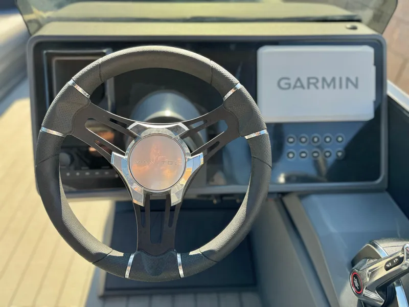 Slide: The Image of Steering wheel of 2025 Manitou Explore 24 Switchback with Garmin navigation system. - 19