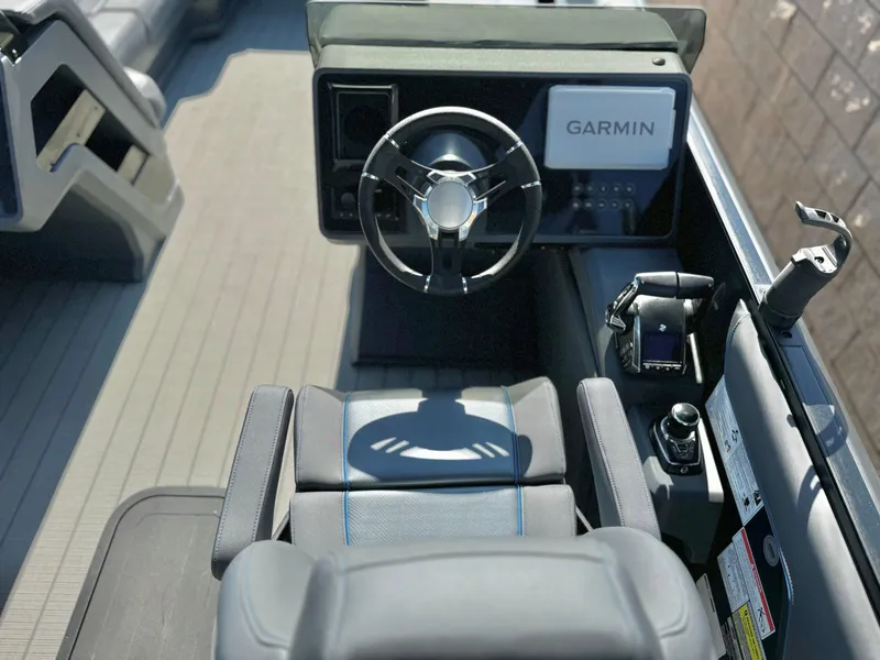 Slide: The Image of 2025 Manitou Explore 24 Switchback boat interior with Garmin navigation system. - 20
