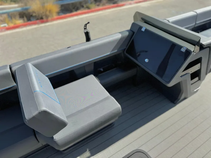 Slide: The Image of 2025 Manitou Explore 24 Switchback boat interior with trifold bench seating. - 23