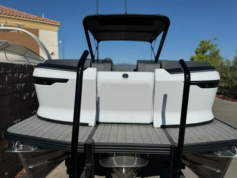 Slide: The Image of 2025 Manitou Explore 24 Switchback boat with trifold bench, rear view. - 3