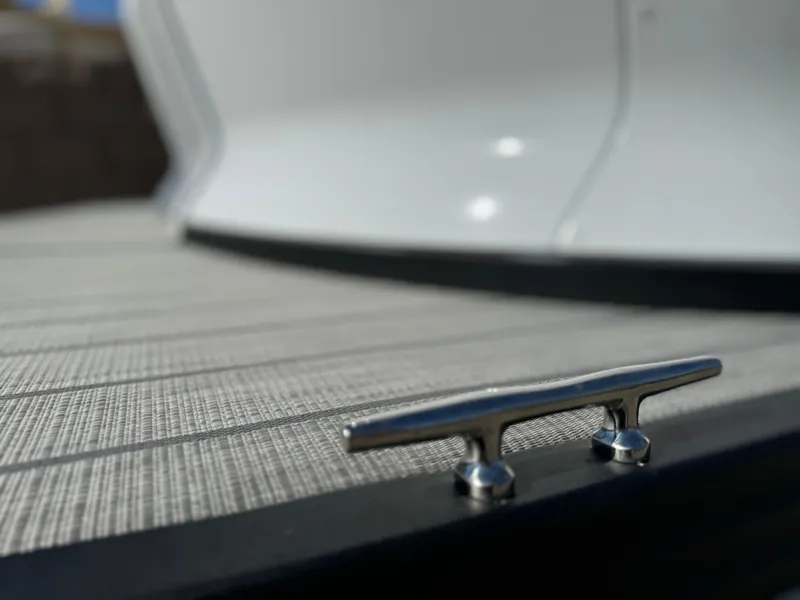 Slide: The Image of Close-up of a 2025 Manitou Explore 24 boat deck with cleat. - 8