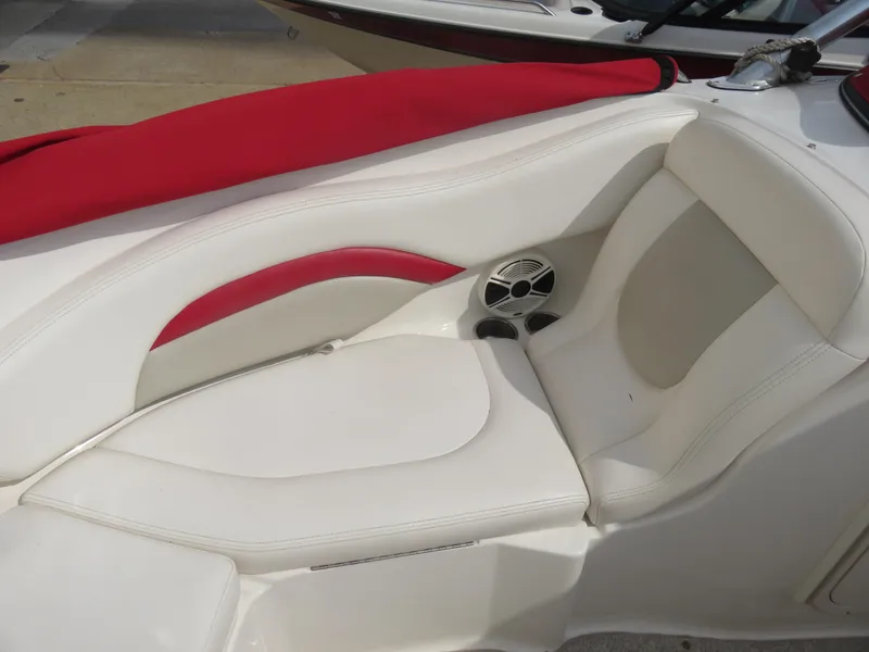 Slide: The Image of 2008 Chaparral SSX 236 boat interior with white and red seating, featuring a built-in speaker. - 11
