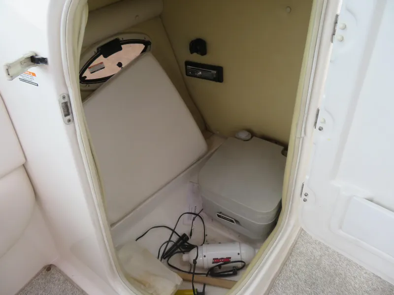 Slide: The Image of 2008 Chaparral SSX 236 boat interior with portable toilet and storage area. - 12