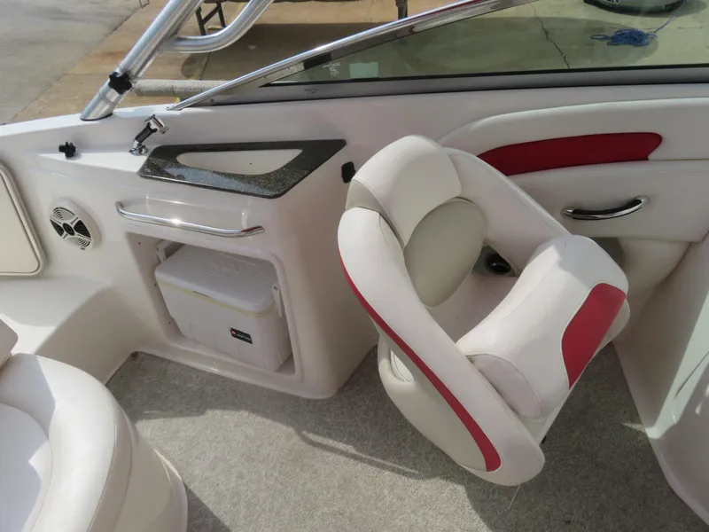 Slide: The Image of 2008 Chaparral SSX 236 boat interior with white and red seating, speaker, and storage compartment. - 6