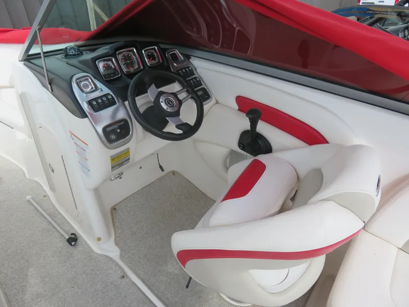 Slide: The Image of 2008 Chaparral SSX 236 boat cockpit with red and white interior, steering wheel, and control panel. - 8