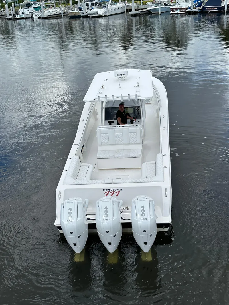 Slide: The Image of 2013 Invincible 42 Open Fisherman boat with triple engines on calm water. - 10