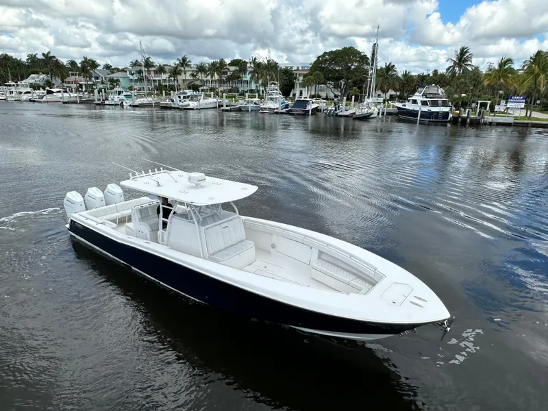 Slide: The Image of 2013 Invincible 42 Open Fisherman boat on calm marina waters. - 15