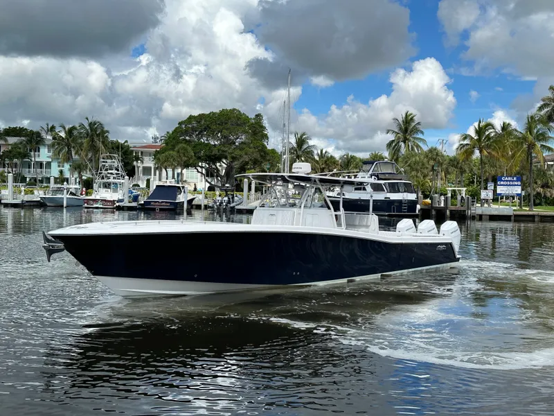 Slide: The Image of 2013 Invincible 42 Open Fisherman boat cruising on a sunny day. - 7