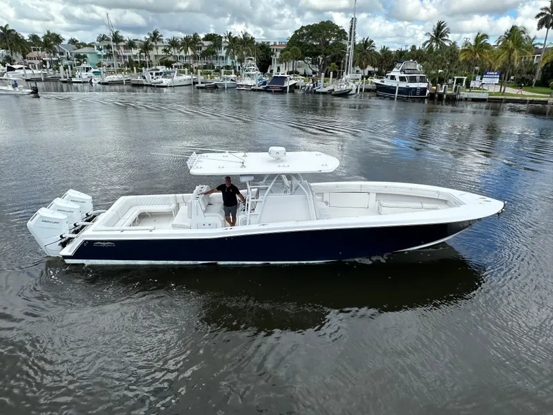 Slide: The Image of 2013 Invincible 42 Open Fisherman boat on calm water near marina. - 8